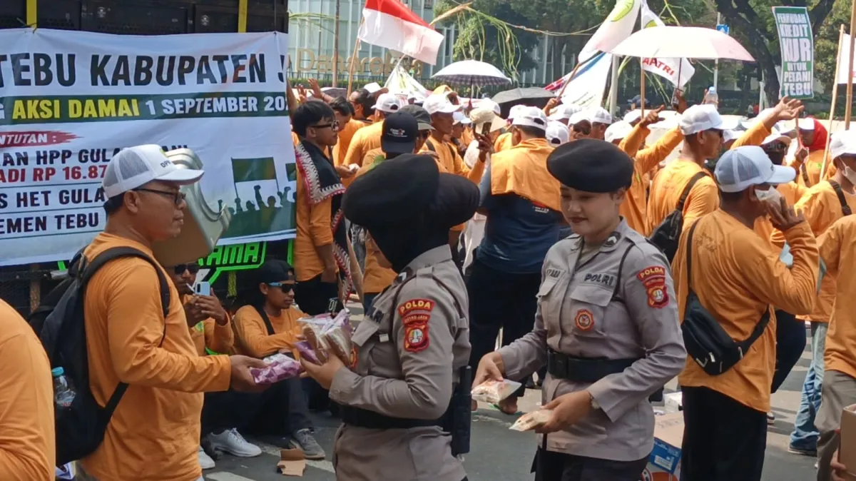Di Bawah Terik Matahari, Polwan Sejukkan Hati Pendemo dengan Roti dan Air Mineral